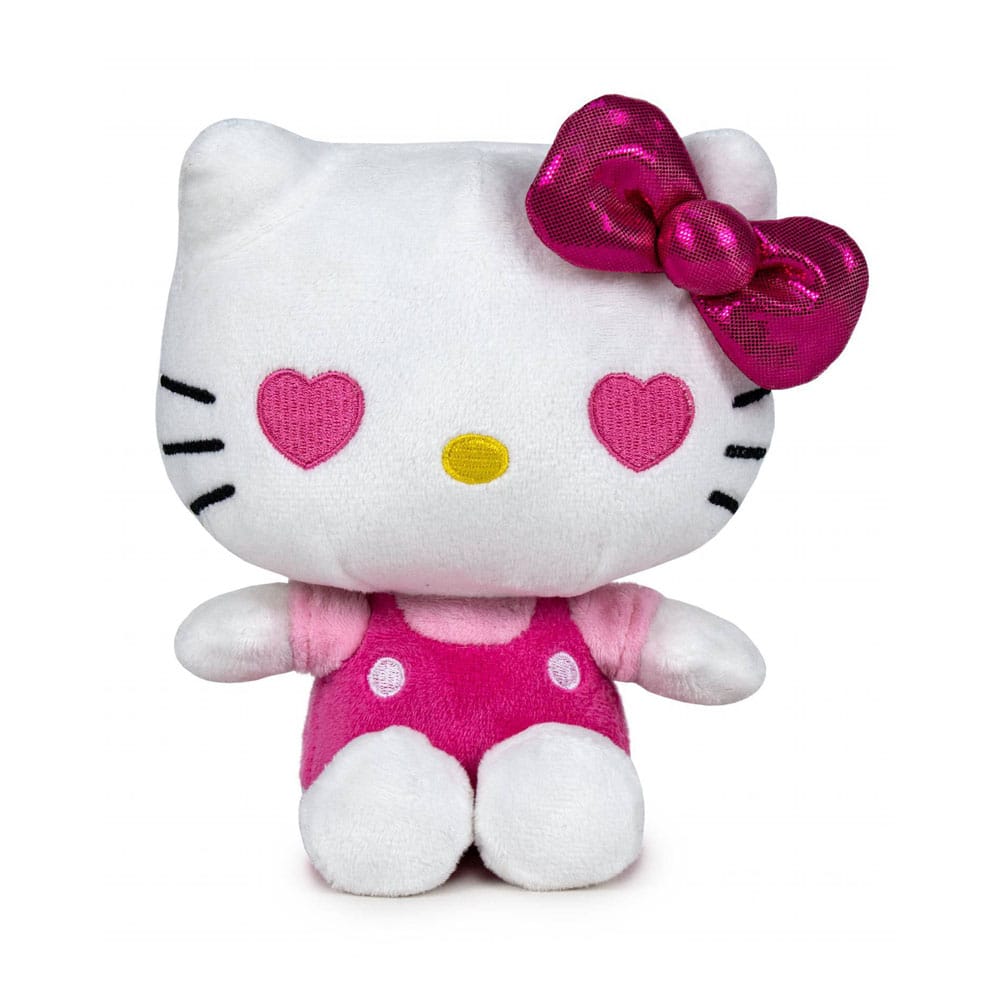 Peluche Hello Kitty 16 cm édition 50e anniversaire, en salopette rose à pois, t-shirt rose clair, nœud rose brillant et yeux en forme de cœur.