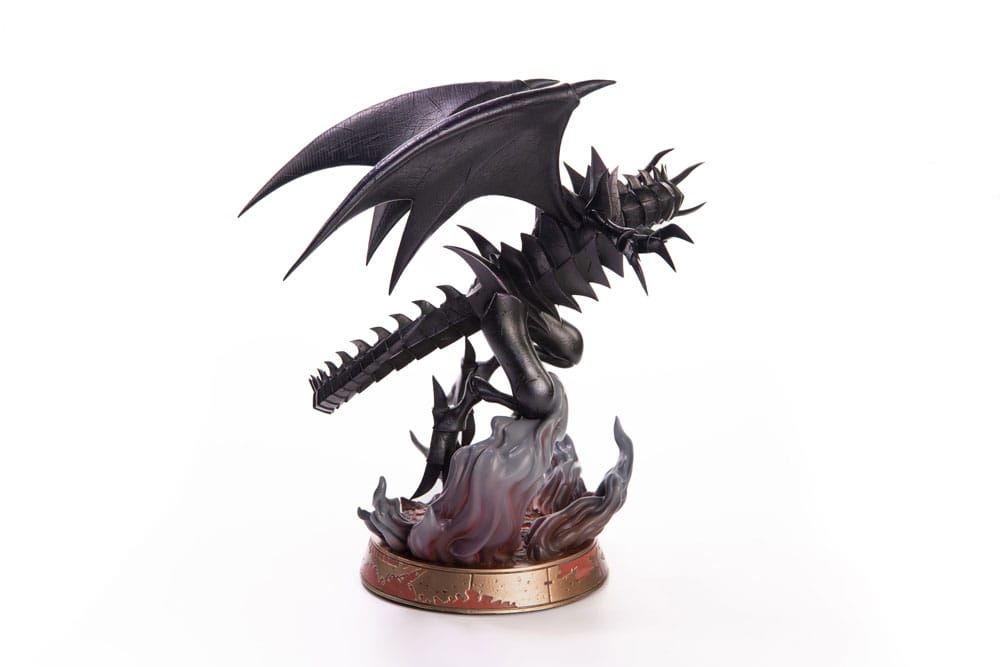 Figurine en PVC de Red-Eyes Black Dragon, le célèbre dragon noir de Yu-Gi-Oh!, dans une pose agressive avec ailes déployées. Le socle est orné de lave en fusion et de roches sombres.
