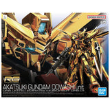 Maquette Gunpla RG 1/144 Akatsuki Gundam Oowashi Unit dorée avec fusil, bouclier et ailes, sur fond blanc.