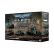 Boîte Warhammer 40,000 Armageddon Bataillon Astra Militarum avec soldats et véhicules blindés sur un champ de bataille.